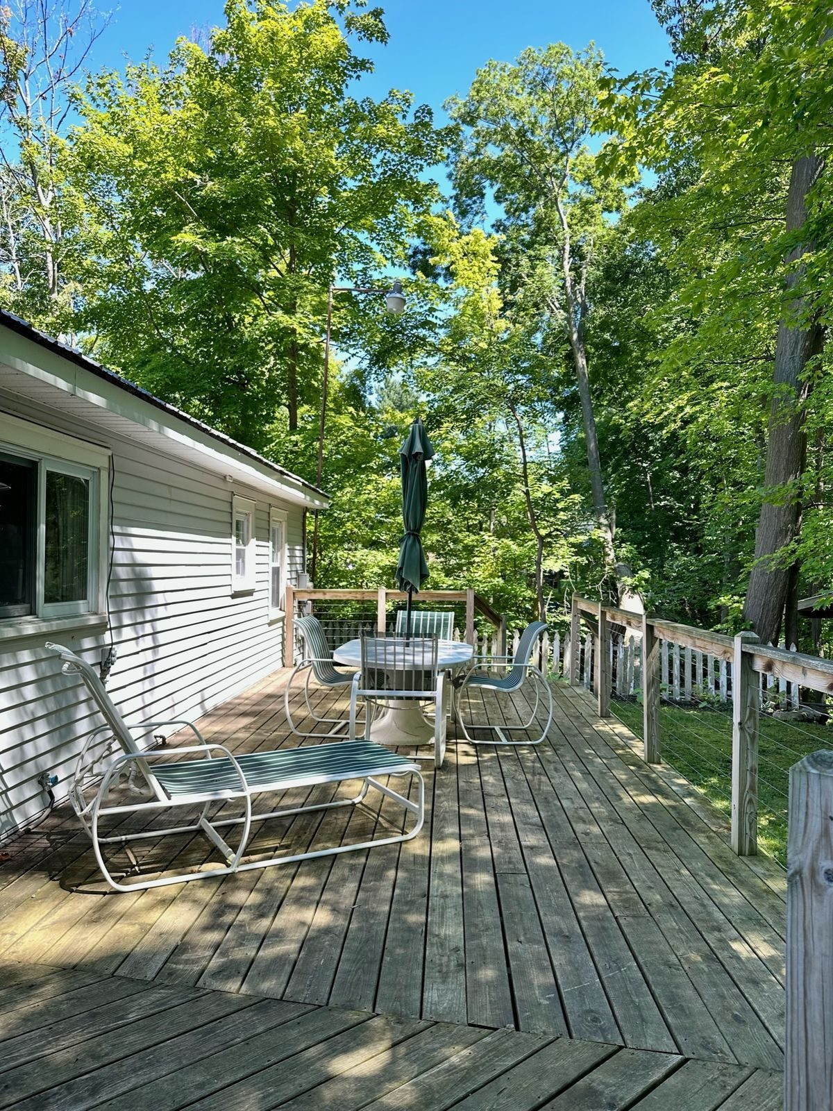 Wraparound deck at the cottage at sunset, overlooking the Oak Orchard River
