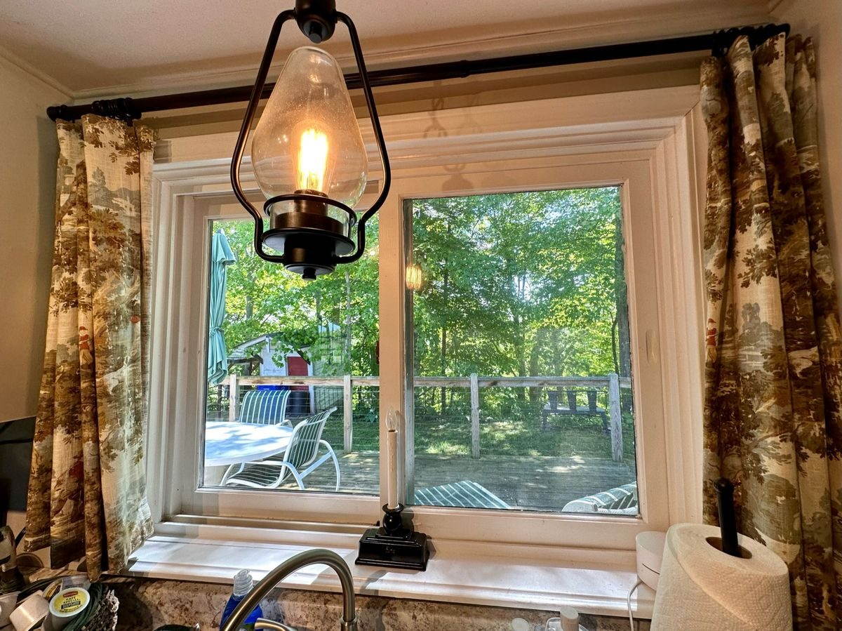 Full kitchen with gas range, riverside window, and morning light